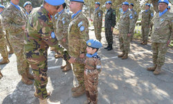 Major General Humayun of Bangladesh, Force Commander of UN Peacekeeping Force in Cyprus (UNFICYP) shaking hands of boy (UN peacekeeper-in-training) at sector 1 medal parade on 31 January 2018, Cyprus.  Photo: UNFICYP/Robert Schütz