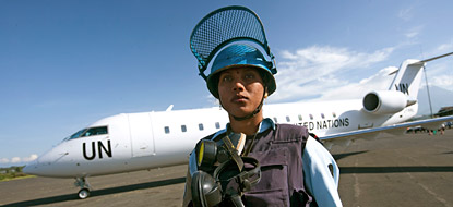 MONUC peacekeeper standing in fron of a UN plane.