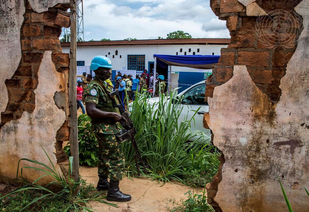 A peacekeeper serving with the mission in the Central African Republic stands guard at a polling station during legislative elections. Photo: UN Photo/Leonel Grothe