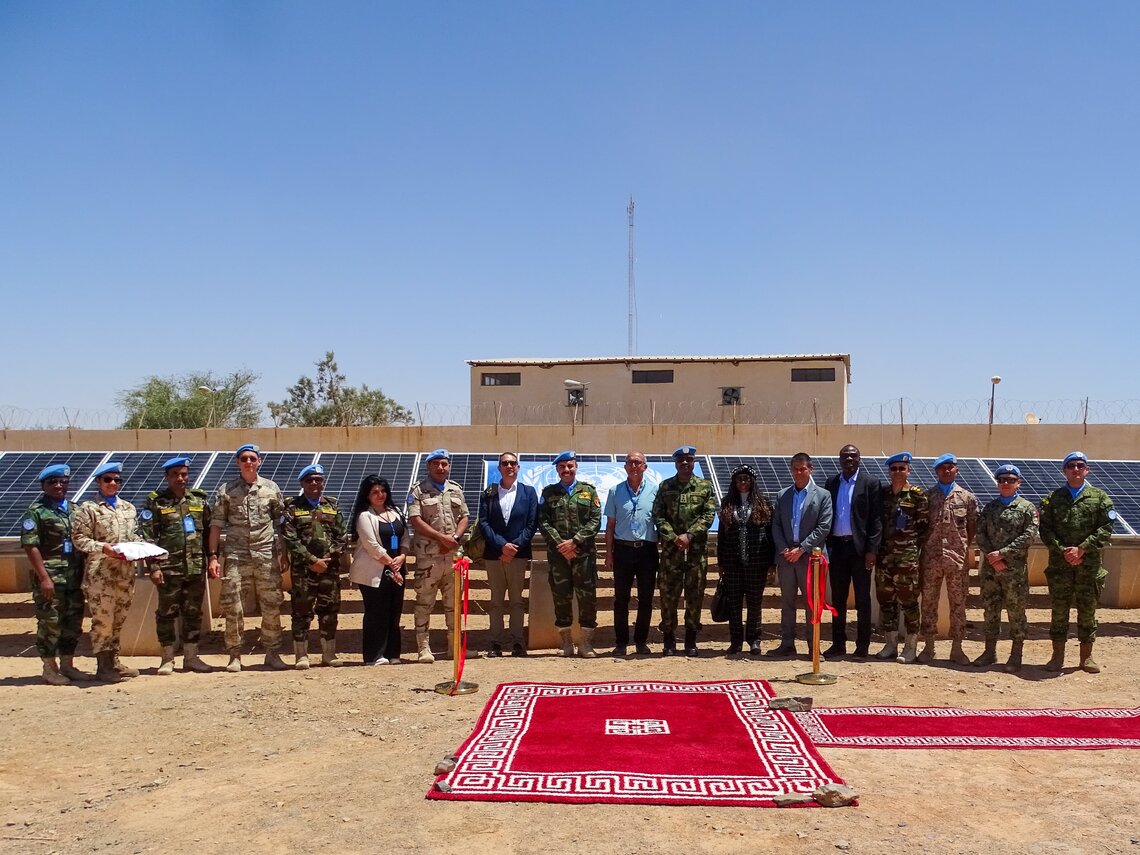 Peacekeepers standing with solar panels