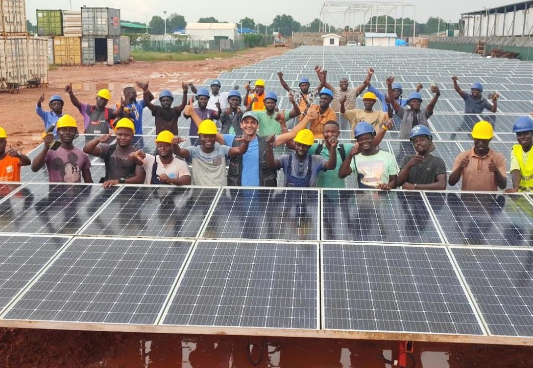 UN peacekeepers pose for a photo with solar panels in the Central African Republic