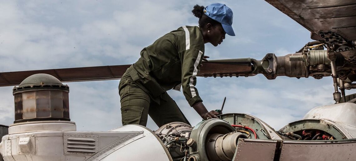 A Senegalese woman peacekeeper works on a helicopter deployed to MINUSCA, the UN peacekeeping mission in the Central African Republic. MINUSCA/Hervé Serefio