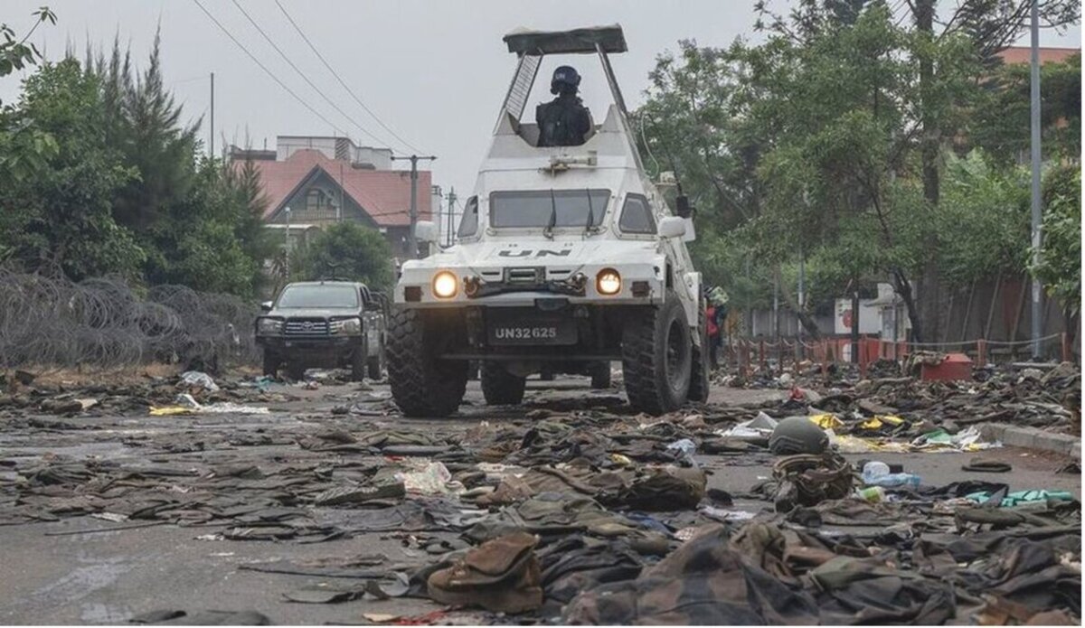 UN peacekeepers patrol Goma in the eastern DR Congo after the city is overrun by rebel forces. In the foreground, military uniforms and equipment have been abandoned on the road. 