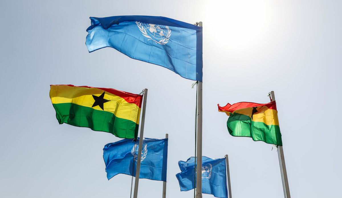 UN and Ghana flags floating in the wind.