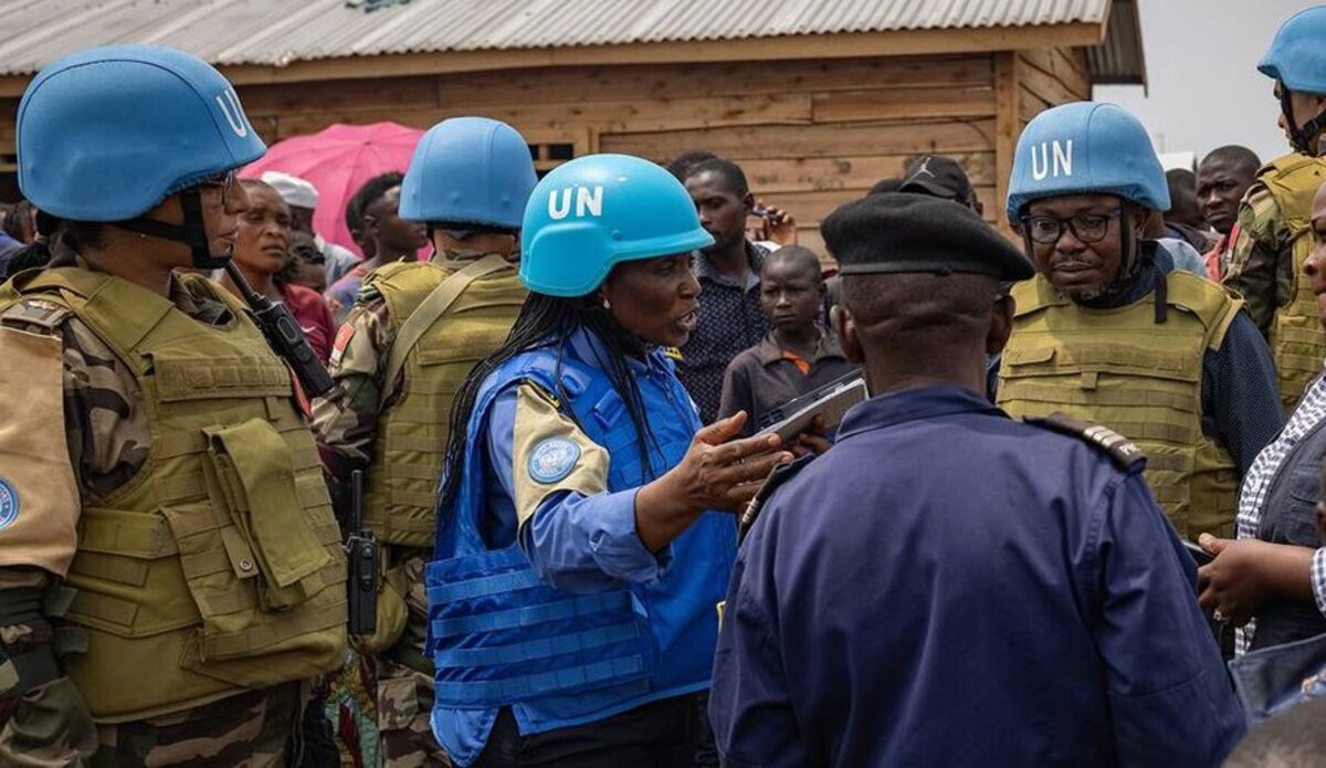 UN police officers talk to displaced people in a camp close to eastern Democratic Republic of the Congo provincial capital Goma.