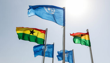 UN and Ghana flags floating in the wind.