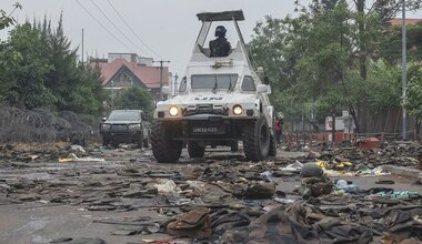 UN peacekeepers patrol Goma in the eastern DR Congo after the city is overrun by rebel forces. In the foreground, military uniforms and equipment have been abandoned on the road.