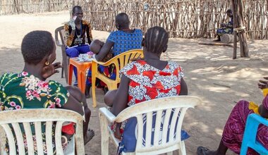 Local community members visit a UN-supported health worker in rural South Sudan, where access to healthcare remains a major challenge.