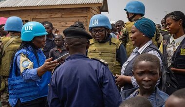 UN police officers talk to displaced people in a camp close to eastern Democratic Republic of the Congo provincial capital Goma. 