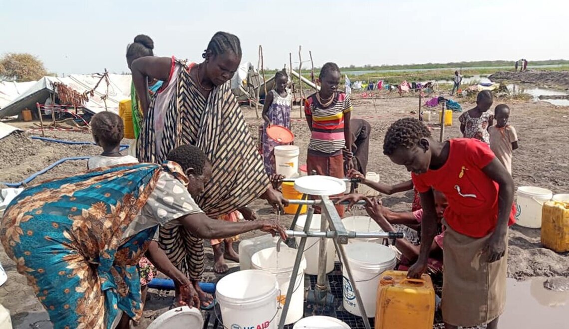 Some of the 20,000 displaced people in Kodok, South Sudan collect water. Photo credit: UN Photo/Nyang Touch
