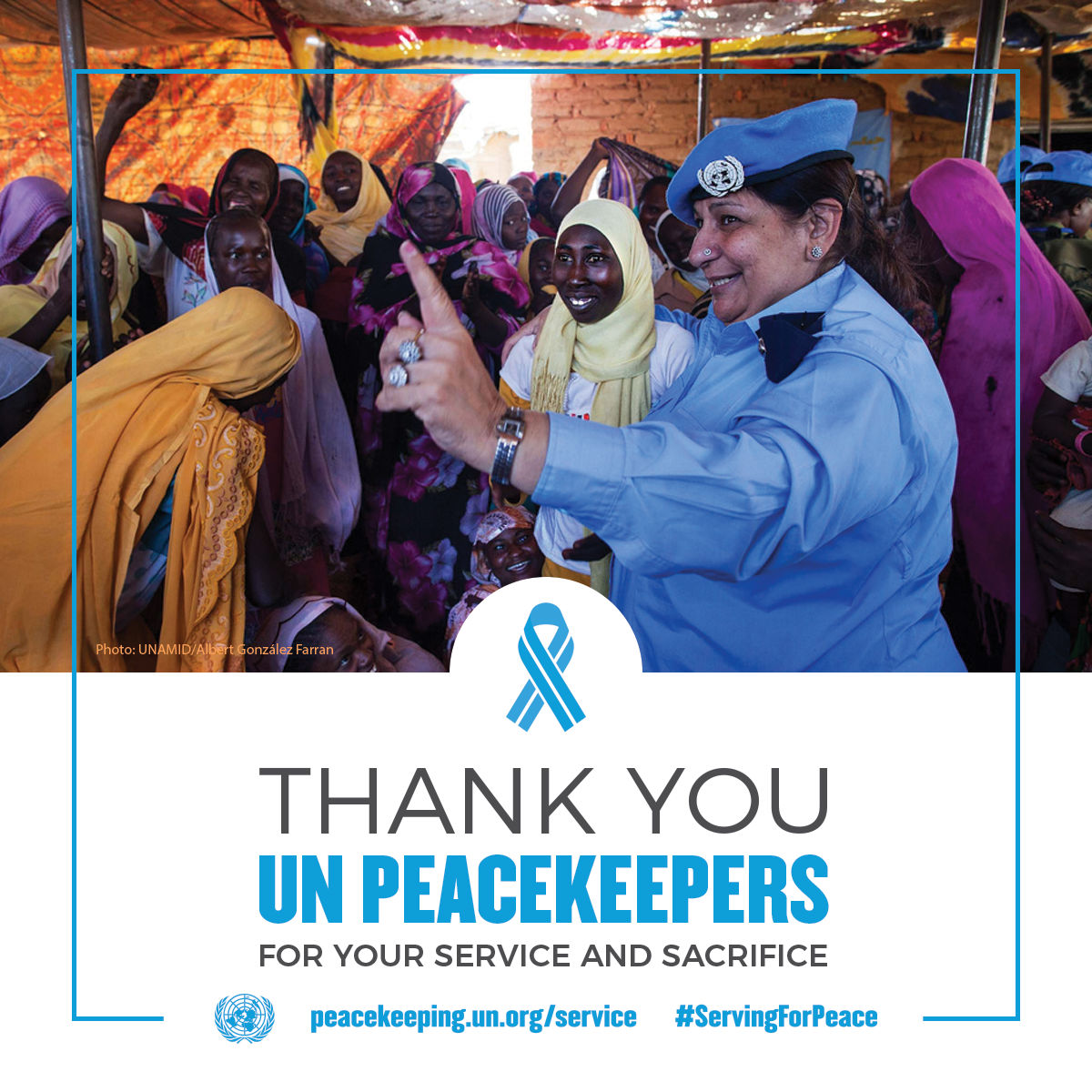 UN Police officer from Pakistan talks with women and girls in Darfur